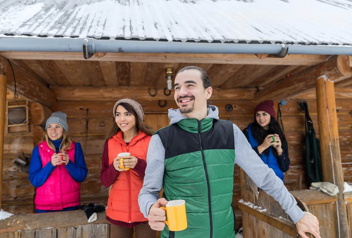 friends drink warm drinks in the snow