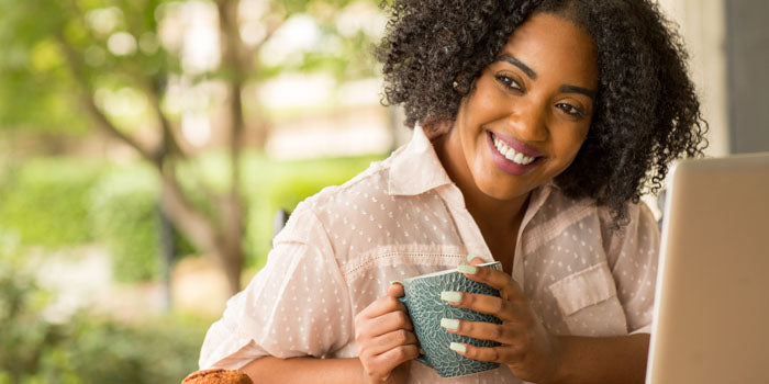 woman smiling at her computer