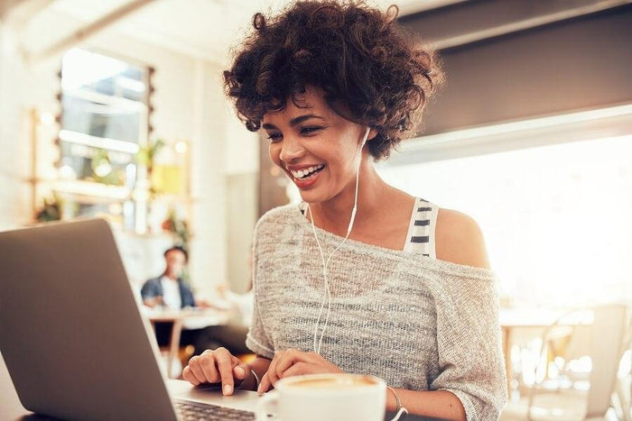 women working hard and listening to music at a coffee shop